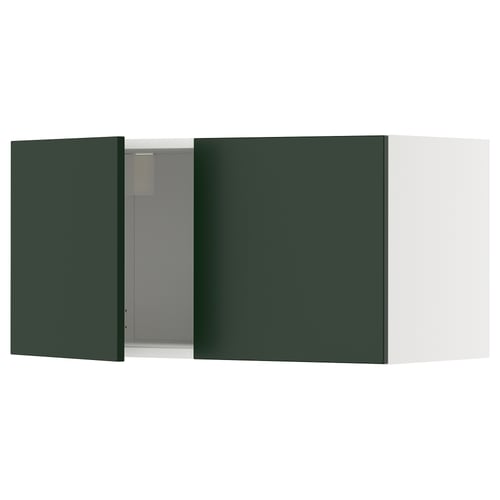 A green METOD kitchen cabinet with a white door open, revealing the interior.