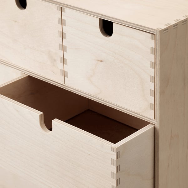 Light-colored wooden chest with multiple drawers. Well-crafted, sturdy design, finished with precise joints.