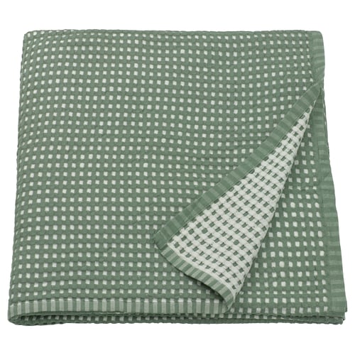 A green PELARTUJA bedspread, reversible, with a waffle texture, made of 100% cotton.
