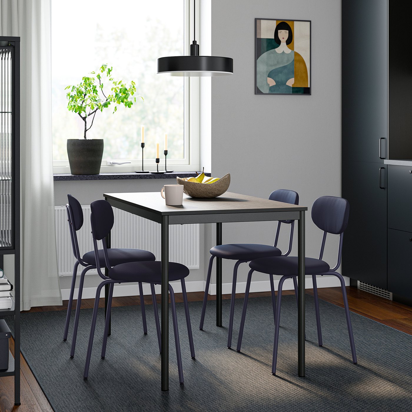 Modern dining setup with dark blue chairs and rectangular table against a window. Grey walls and decor included.