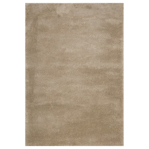A beige STOENSE rug. Its rectangular, soft, with a slightly shiny surface. Ideal for large or small rooms, it dampens sound and feels cosy.