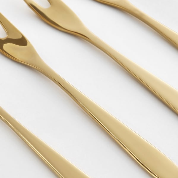 Gold-colored metal forks; sleek, shiny, and elegant; arranged neatly, reflecting light.