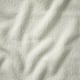 Close-up of soft, textured, ivory-colored fabric, showcasing its plush, inviting quality.