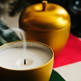 VINTERFINT Scented candle in metal tin, apple-shaped/Apple and cinnamon gold-colour, 24 hr