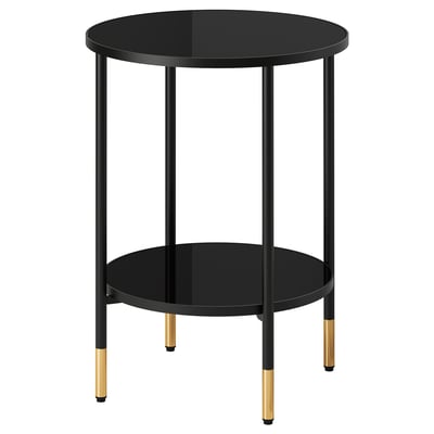 Masă laterală elegantă neagră ÄSPERÖD cu blat din sticlă fumurie, accente aurii și patru picioare pentru decor modern.