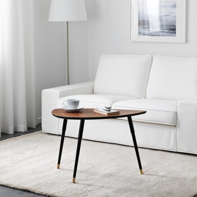 Măsuță de cafea minimalistă cu 3 picioare și picioare din alamă, care ține cană și cărți.