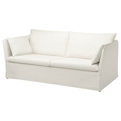 A white BACKSÄLEN sofa. It has a minimalist design with clean lines and plush cushions. The fabric is a soft, machine-washable cotton blend.