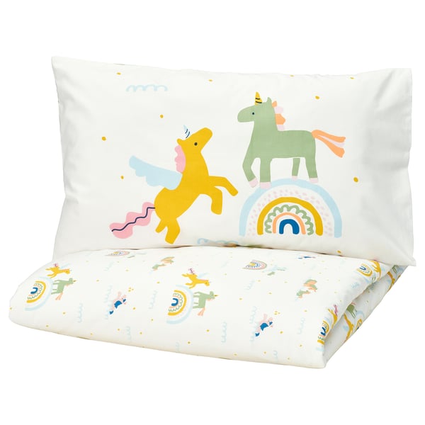 This image shows a yellow BARNDRÖM pillow with unicorn and rainbow design. The pillow is made of recycled cotton.