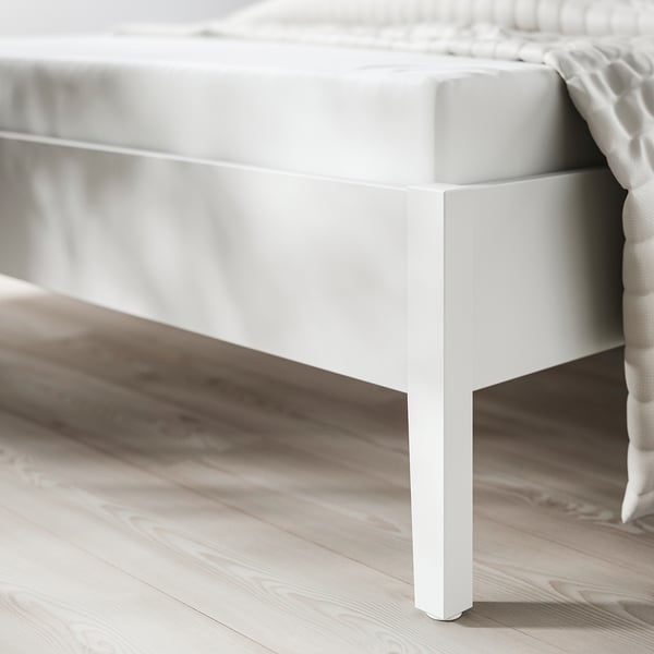 Modern bed frame with sleek white legs, part of the GULLABERG series, highlighting clean lines and robust craftsmanship.