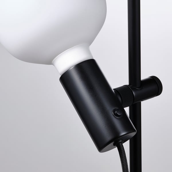 Modern floor lamp with frosted globe bulb, adjustable neck, and sleek black base. Wireless dimming capabilities.