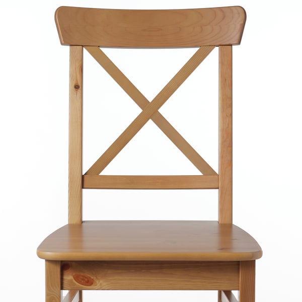 Sturdy wooden chair with high back, light finish, triangular seat support.