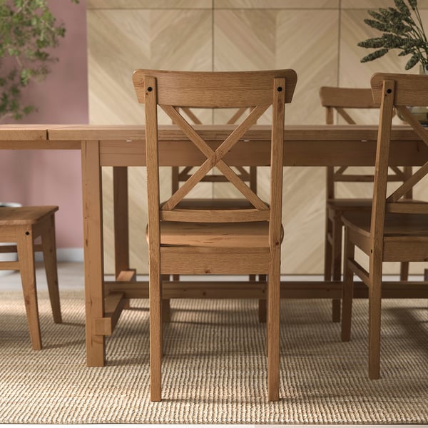 Wooden dining chairs with high backs, part of the INGOLF series, designed for comfort and durability with solid pine construction.