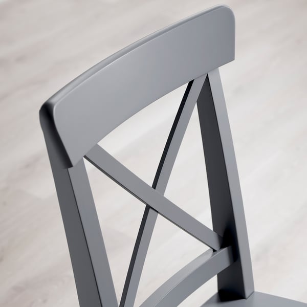 Modern chairs backrest, sleek design, robust wood frame.