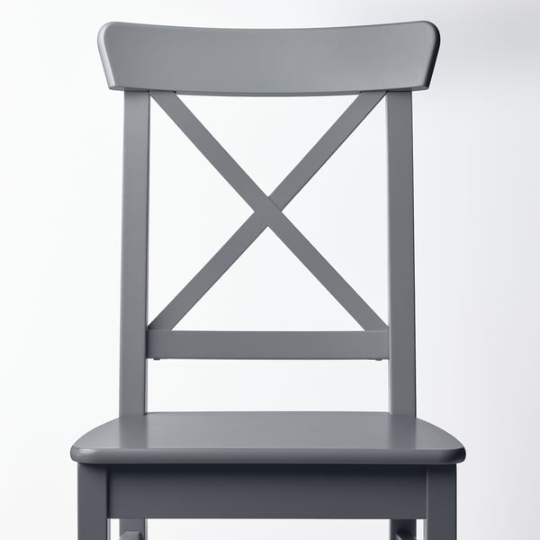 Grey modern chair, sturdy design, wooden frame, sleek lines, solid construction.