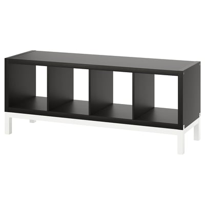 Black KALLAX shelving unit with four open cubbies, standing on white metal legs, modern design.