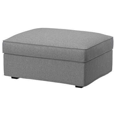 The KIVIK footstool is grey, rectangular, with a plush cushioned seat and discreet herringbone pattern. It a hidden storage compartment underneath.