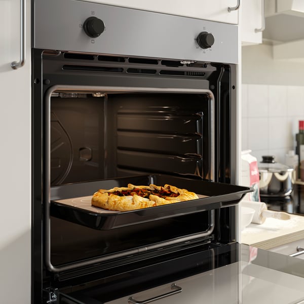 Oven baking tray with food.