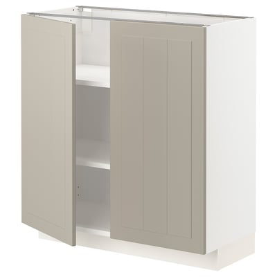 A beige METOD cabinet with two doors open, revealing shelves inside.