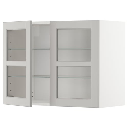 White METOD kitchen cabinet with glass doors and shelves.
