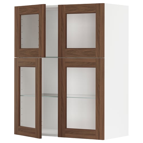 A METOD kitchen cabinet with walnut doors and glass shelves.