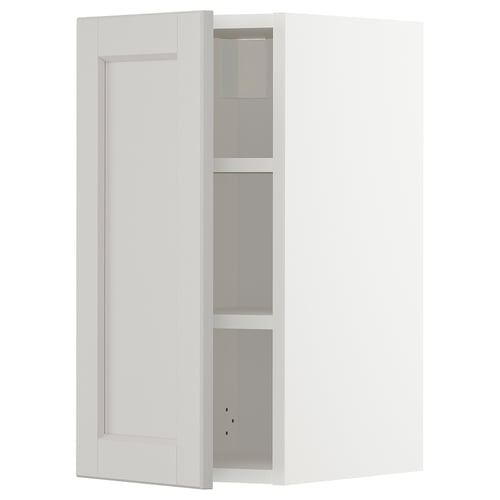 A white METOD kitchen cabinet with light grey lerhyttan fronts and adjustable shelves.