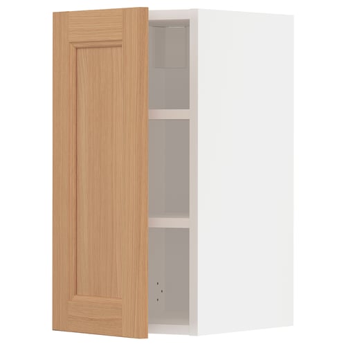 An open light brown wooden ikea METOD wall cabinet with a white interior and two shelves.