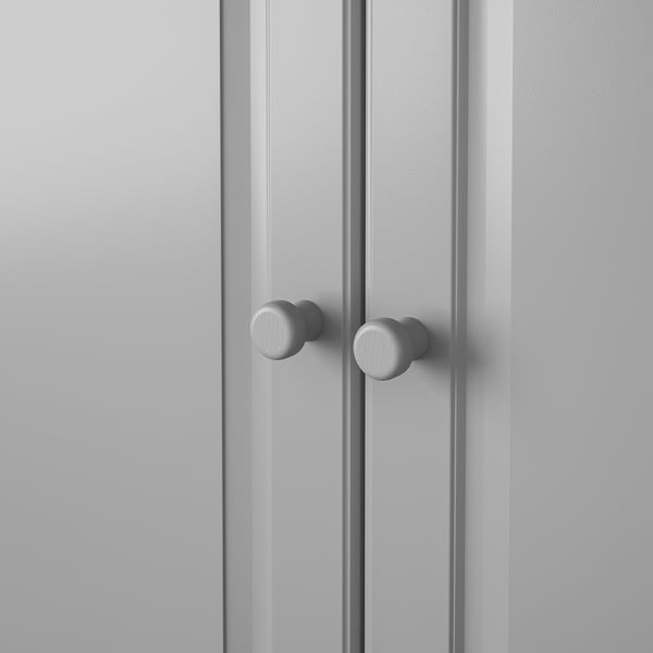 Two round knobs on grey wooden doors, smooth surface, solid beech design.