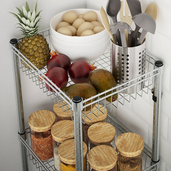 Metal kitchen shelf holding fruit, bowls, wooden boards, and utensils.