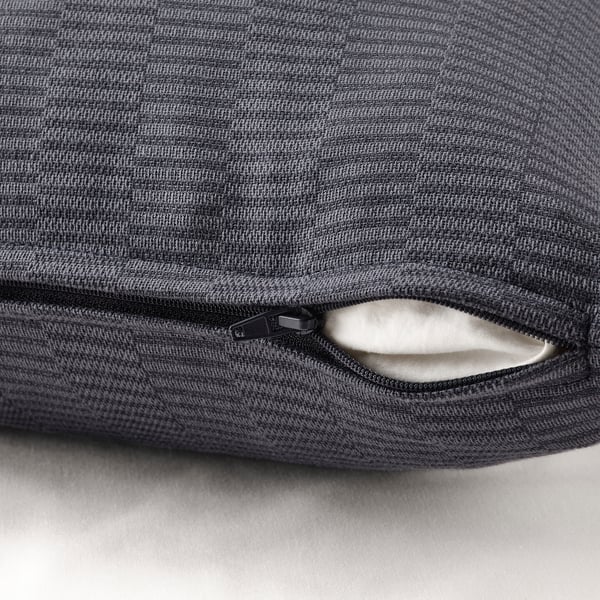 Close-up of PLOMMONROS cushion cover in grey with visible zip.