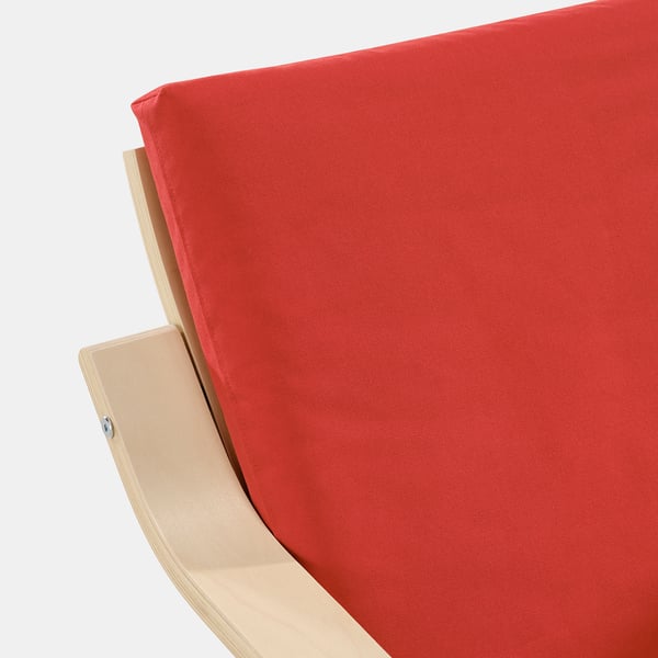 Red cushioned chair corner, showing smooth fabric and curved wooden frame detail.