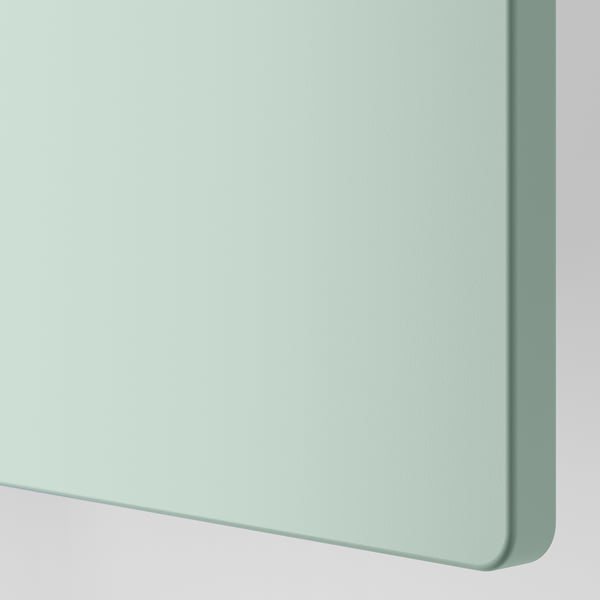 It shows part of a modern wardrobe with smooth, mint-green surface, highlighting its sleek, durable design.