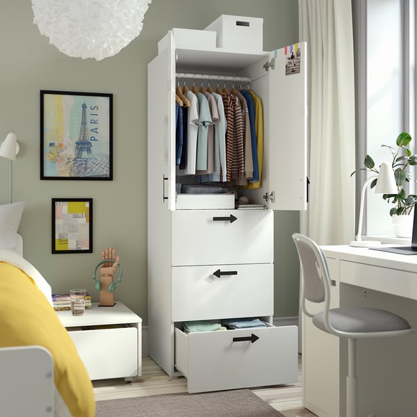 Small bedroom with SMÅSTAD wardrobe, desk, and bed. Wardrobe holds clothes and has adjustable feet.