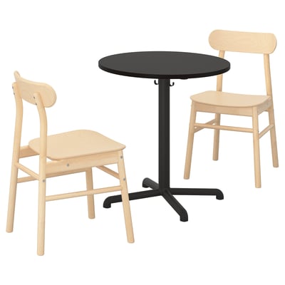 A STENSELE dining set with a black round table and two light wooden chairs. The chairs have curved backs and seats for comfort.