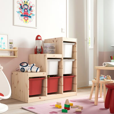 Wood TROFAST kids shelf with red bins, toys, and stuffed animal.