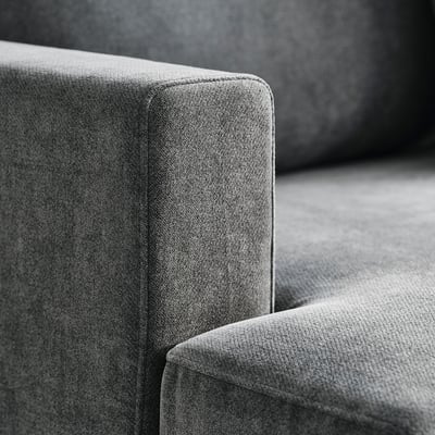 Close-up of modern upholstered couch, focus on texture and stitching.