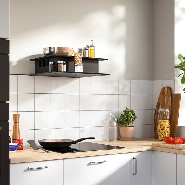Modern kitchen with VIGGBO black range hood, shelves holding cooking items.
