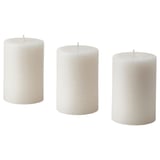 Three white ADLAD scented candles, cylindrical shape, simple design, made from plant-based wax, stand side by side.