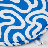 Blue and white rounded chair pad with swirly design, edged neatly, appears durable.