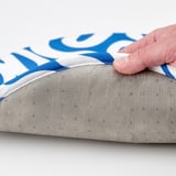 Hand lifts ÄNGSFRÄKEN chair pad, reveals non-slip backing with swirl design.