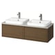Double wall-mounted vanity in brown oak with two white square basins, chrome faucets, and dark handles.