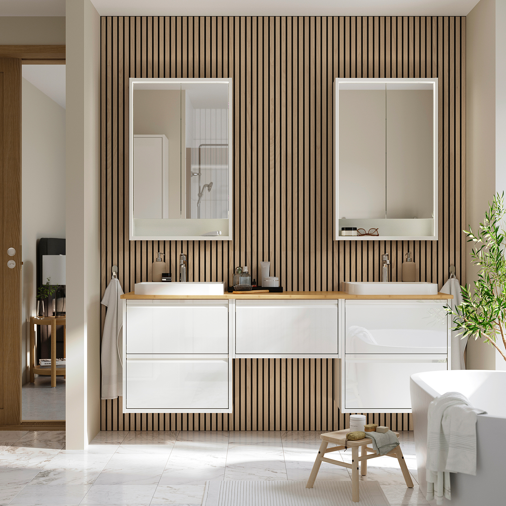 Modern bathroom with dual white ÄNGSJÖN vanities, sleek countertops, and large mirrors. Parquet wooden walls and marble floors create a spacious feel.