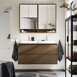 Modern bathroom with floating oak vanity, marble basins, mirror cabinet, and tiled shower.