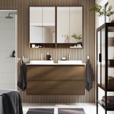 Modern wooden brown bathroom vanity with dual sinks, sleek cabinet design, and large mirrors.