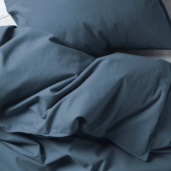 Soft, crumpled blue-gray bedding; looks plush, comfortable.