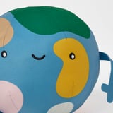 Soft, plush earth toy with embroidered face, colorful continents, and recycled materials for hugging and play.