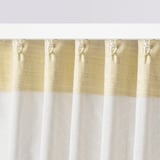 Close-up of light-filtering curtains with a subtle pattern, featuring hooks along the top edge for easy installation.