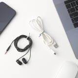 Desk with devices: grey laptop, black smartphone, ALFORSIT white & black cable ties, and a white mouse.