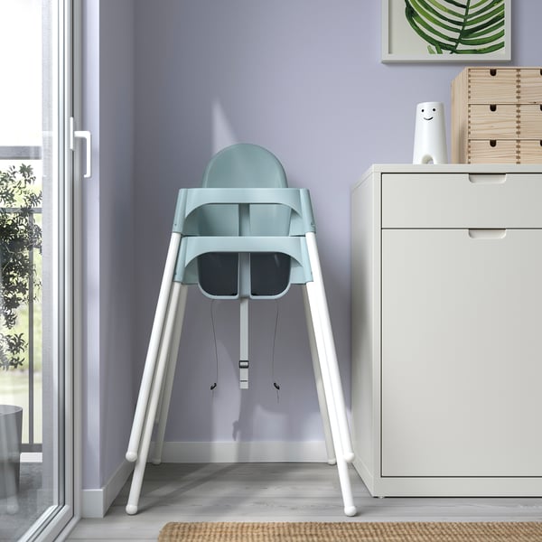 Teal ANTILOP high chair by window, portable & safe for kids up to 3yrs or 15kg, with safety belt.