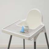 Small ANTILOP high chair, white, with blue silicone place-mat, simple design, fits in corners.