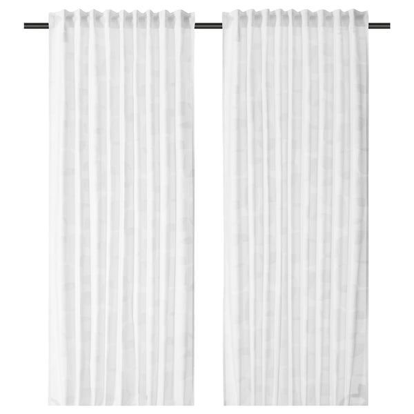 Two white, semi-sheer curtains hang side by side, featuring a subtle geometric pattern and a tailored, pleated design.